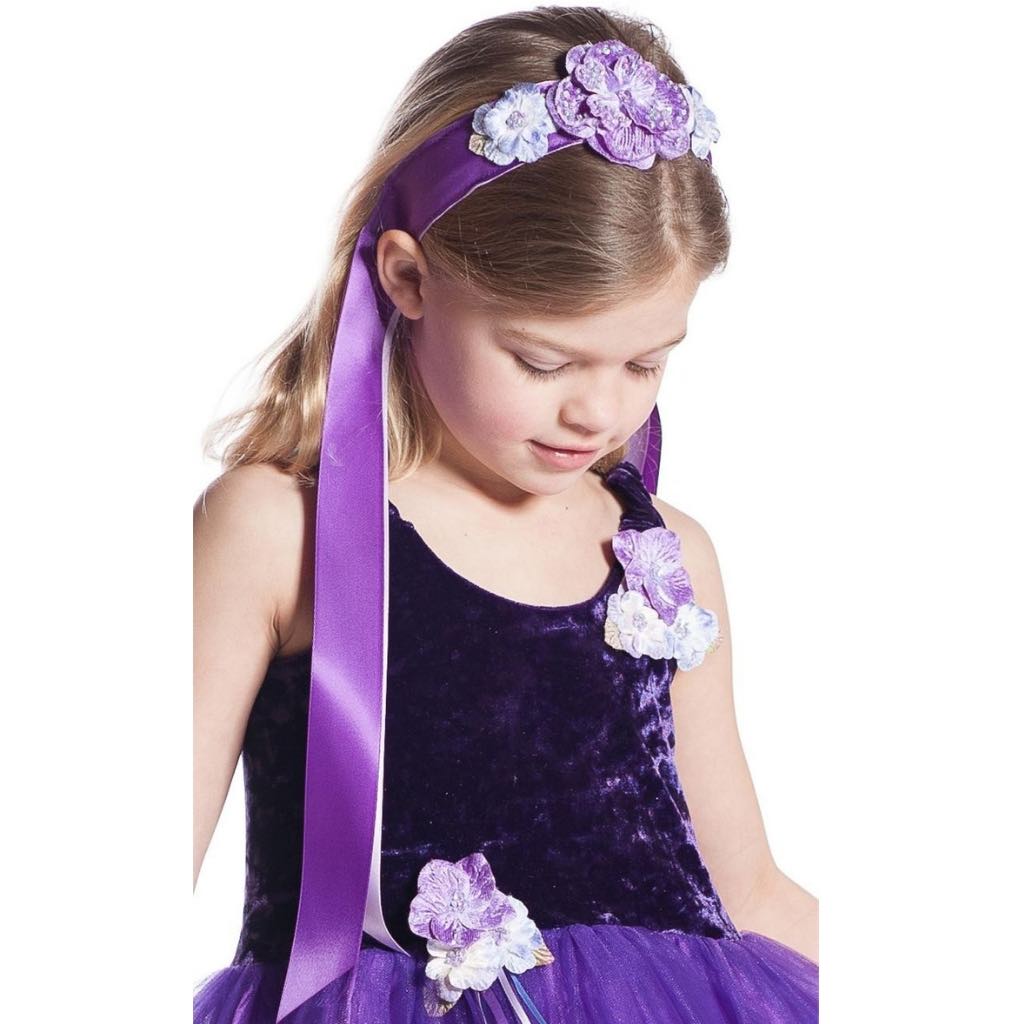 Girl wearing purple flower ribbon headband