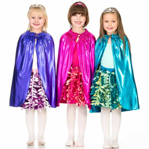 three girls wearing shiny costume capes and party petal skirts