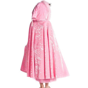 girl wearing pink velvet hooded cape standing with back to camera