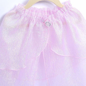 closeup of pink shimmery cape with jewel clasp