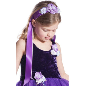 Girl wearing purple flower ribbon headband